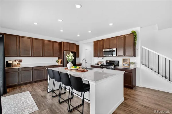 a kitchen with sink cabinets and wooden floor