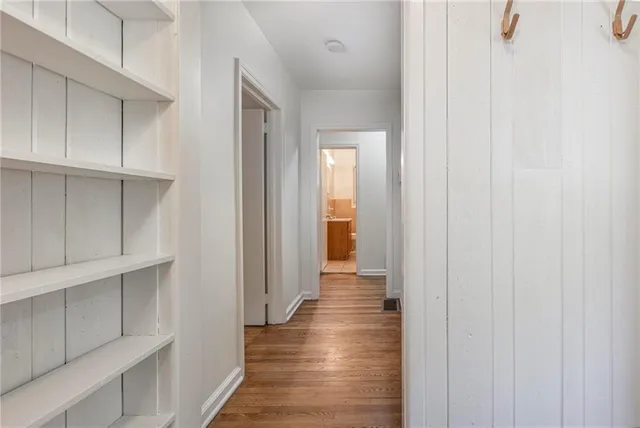 a view of a hallway with wooden floor