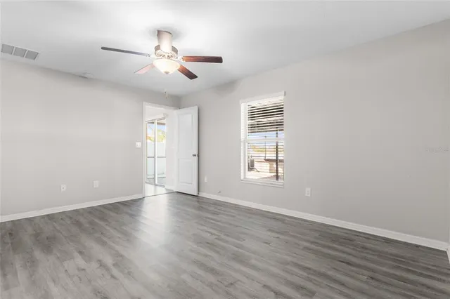 wooden floor in an empty room with a window