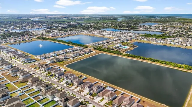 an aerial view of residential houses with outdoor space