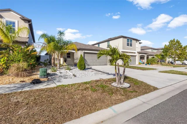 a swimming pool with yard in front of it
