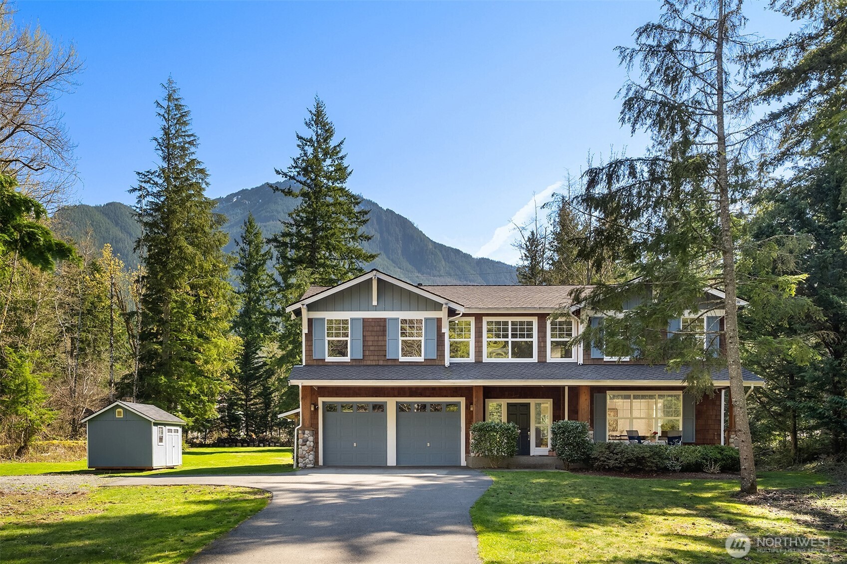 47419 Southeast 157th Place North Bend, WA 98045 - Photo 1 of 39 a front view of a house with a garden and swimming pool