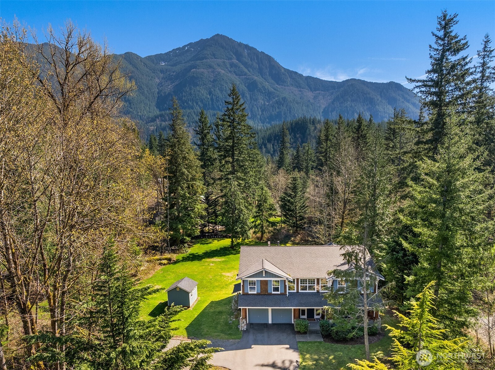 47419 Southeast 157th Place North Bend, WA 98045 - Photo 3 of 39 a view of a house with a mountain and a forest