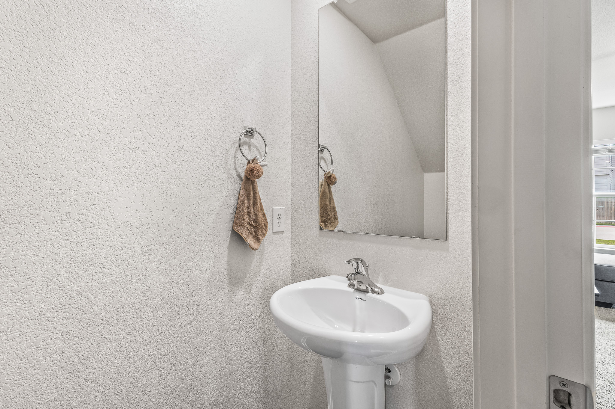 304 Hyacinth Way, Unit #7K Jarrell, TX 76537 - Photo 10 of 26 A well-lit half bathroom featuring a pedestal sink and contemporary wall mirror.
