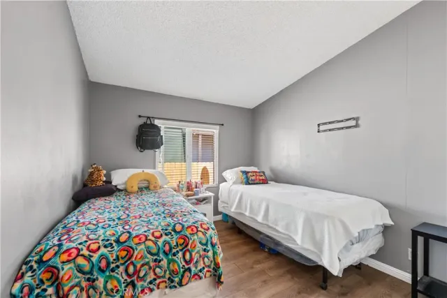 a bedroom with two beds and a window