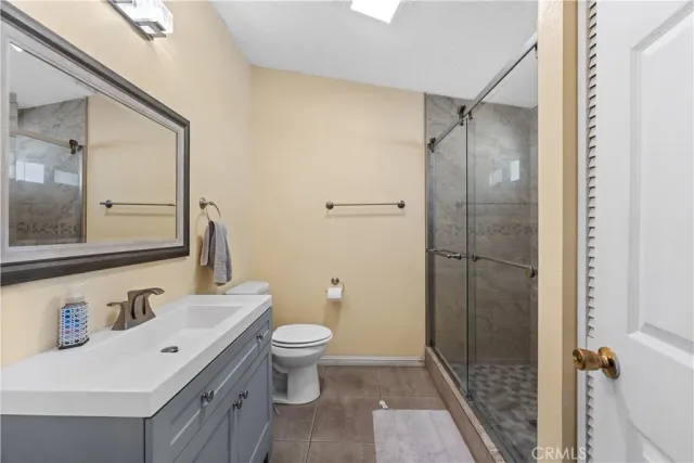 a bathroom with a bathtub shower sink mirror and toilet