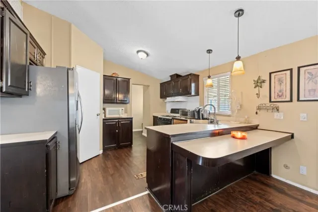 a kitchen with stainless steel appliances a stove refrigerator sink and microwave