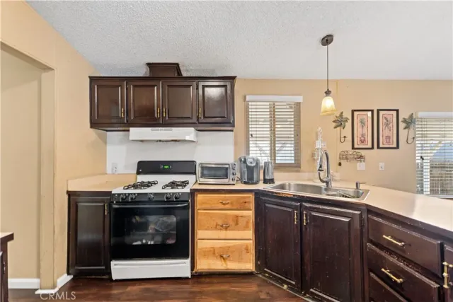 a kitchen with a stove sink and cabinets