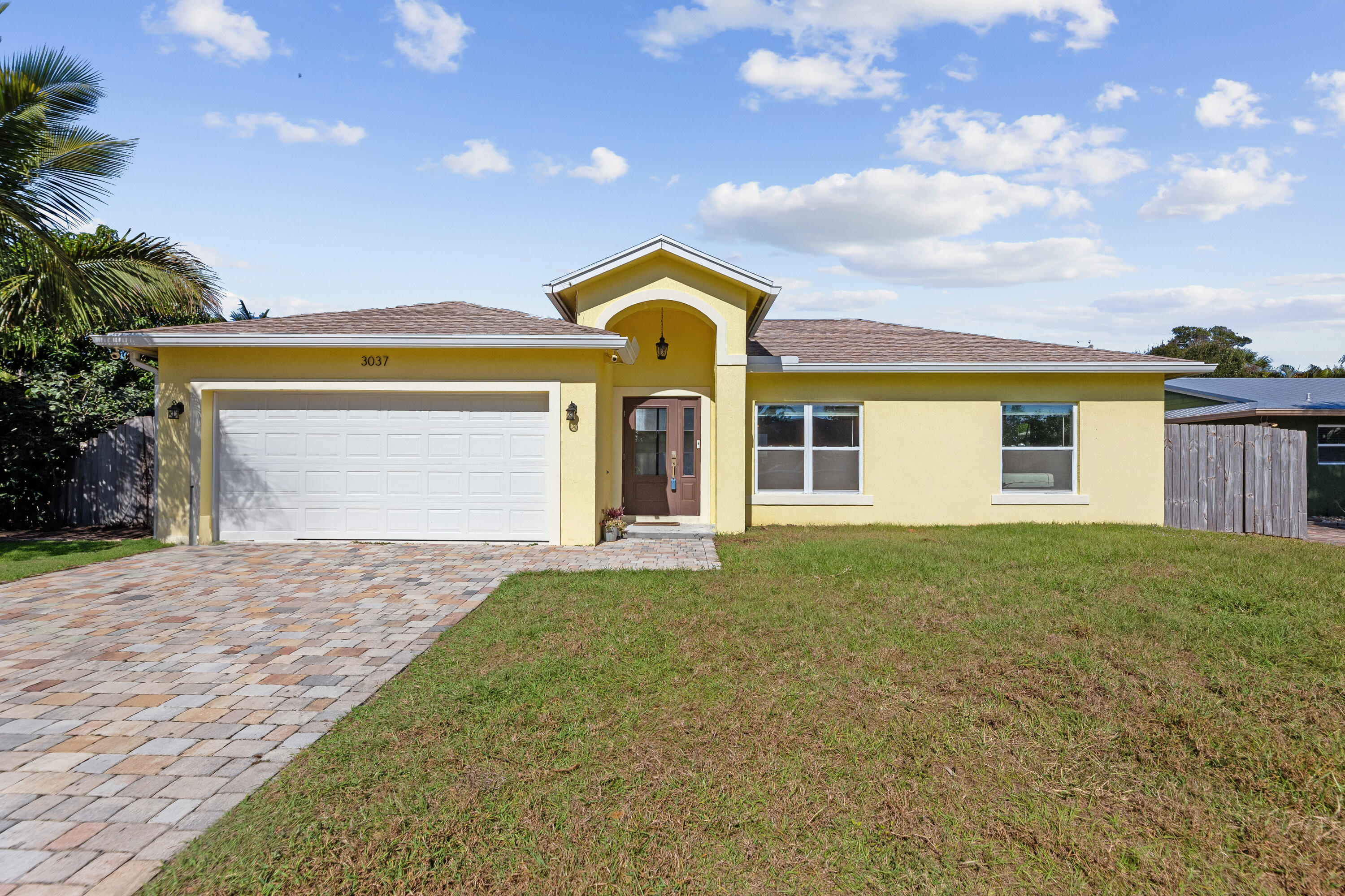 3037 Southeast Iris Street Stuart, FL 34997 - Photo 1 of 36 a view of a house with a garden and deck