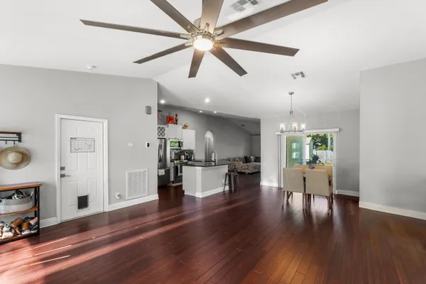 a living room with furniture and kitchen view