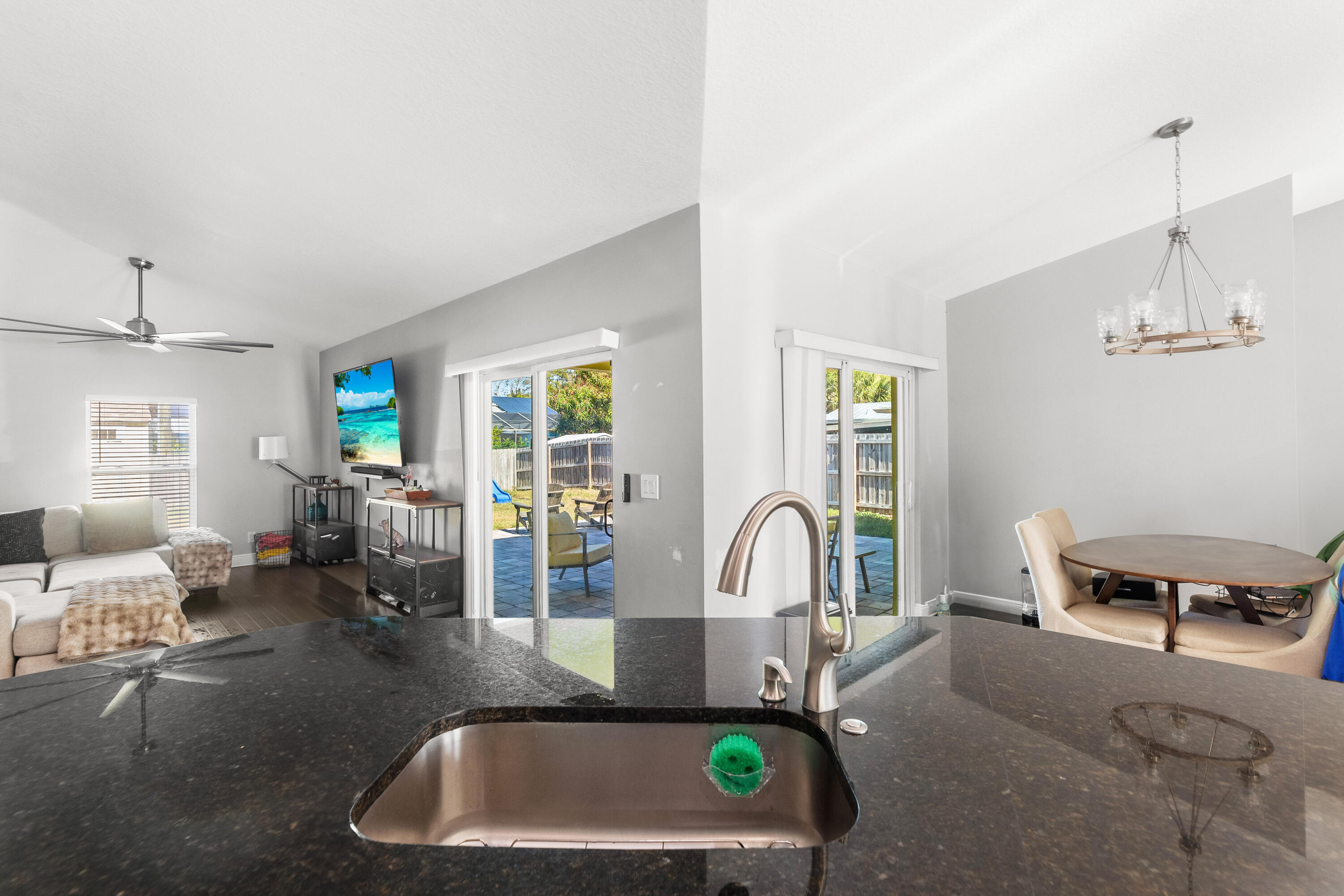 3037 Southeast Iris Street Stuart, FL 34997 - Photo 14 of 36 a kitchen with a sink a counter and chairs