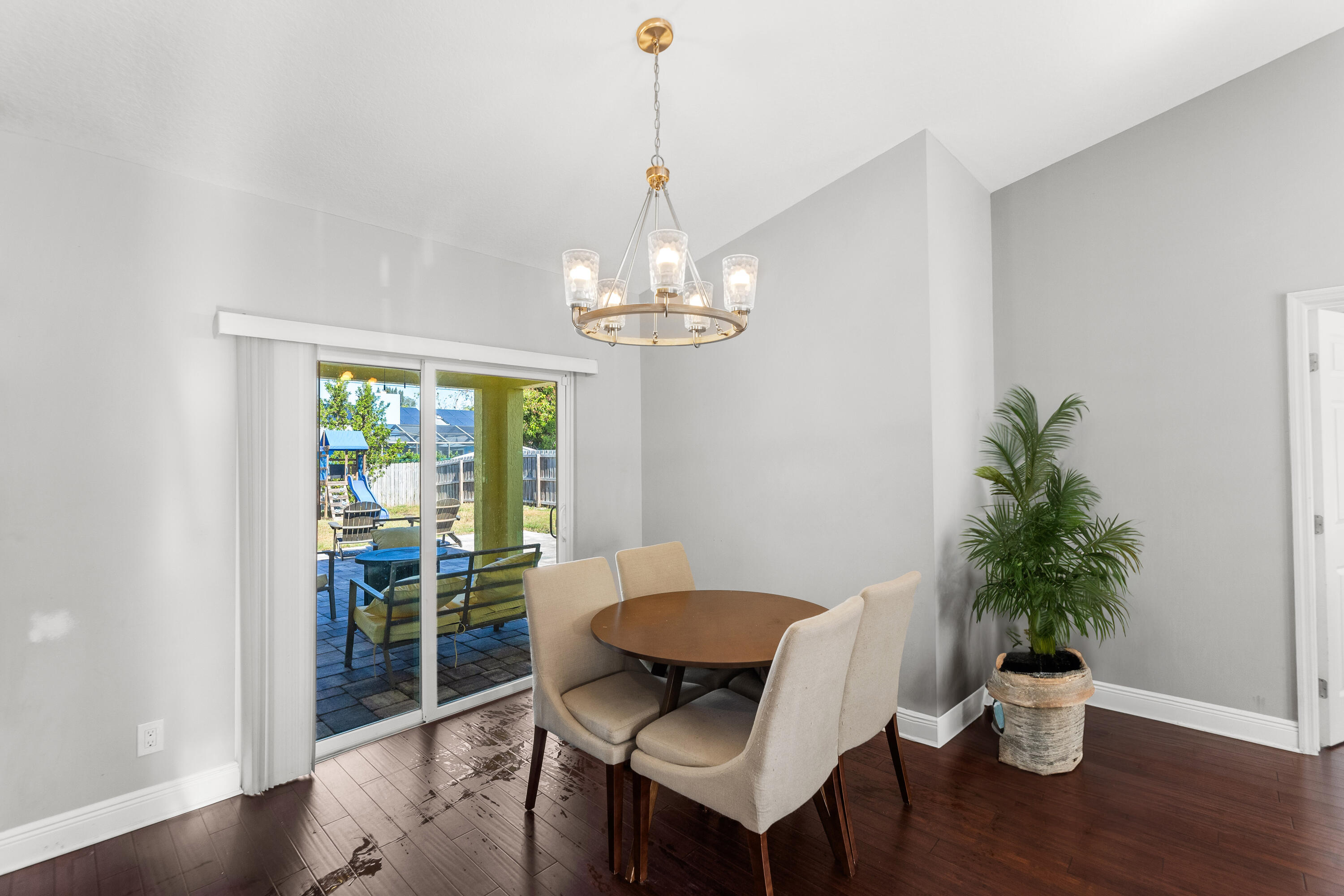 3037 Southeast Iris Street Stuart, FL 34997 - Photo 15 of 36 a view of a dining room with furniture window and wooden floor