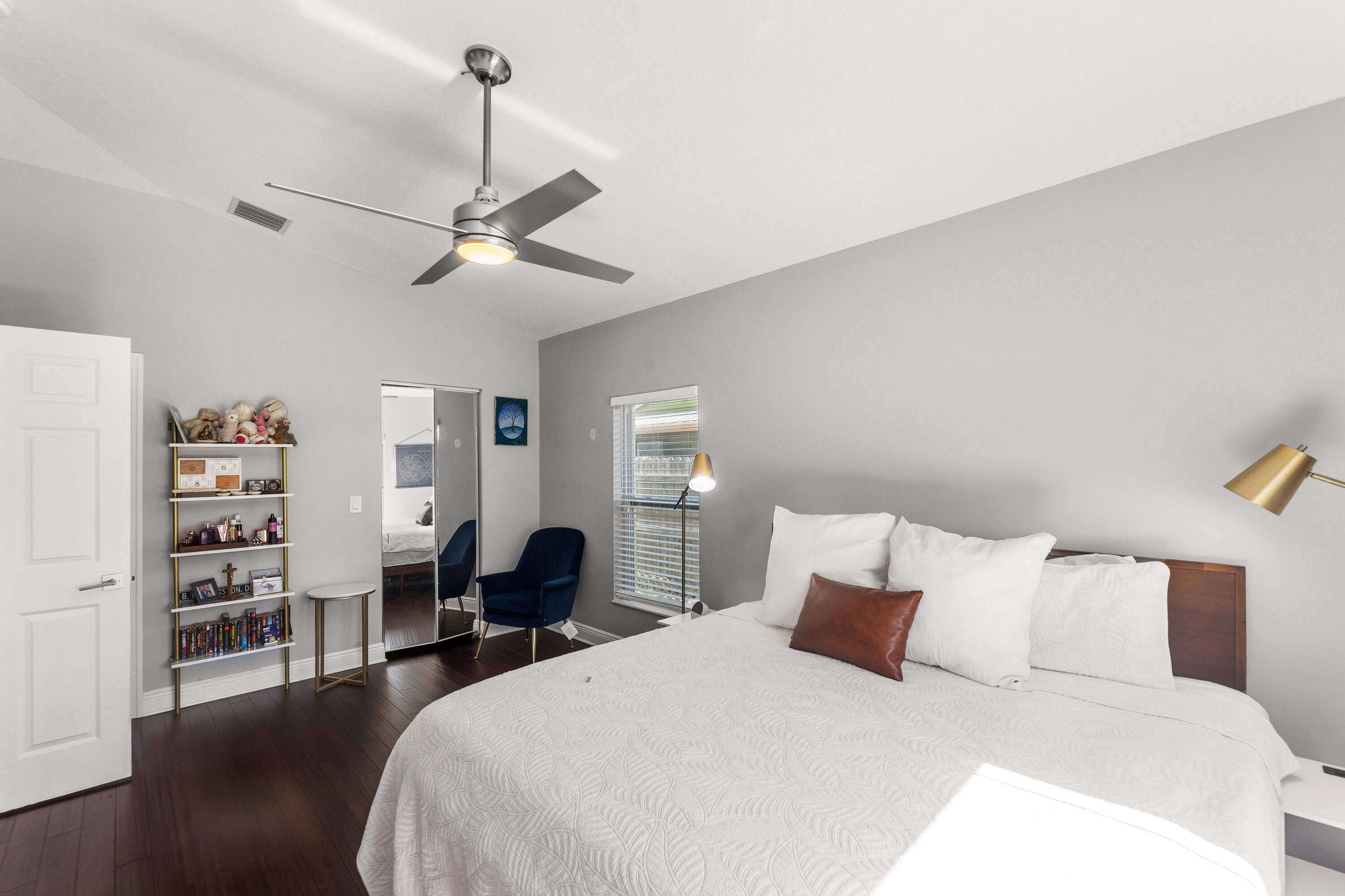 3037 Southeast Iris Street Stuart, FL 34997 - Photo 18 of 36 a bedroom with a bed and a chandelier