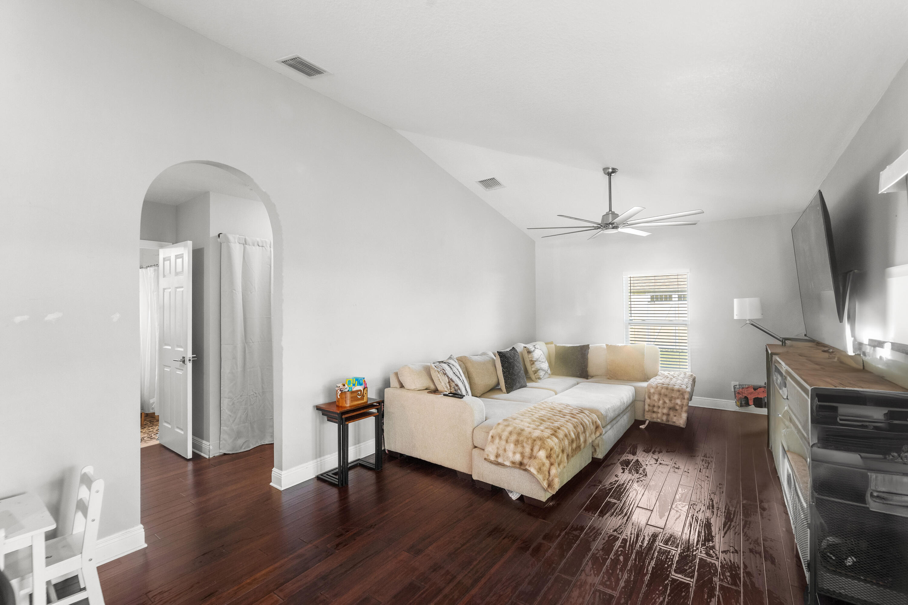 3037 Southeast Iris Street Stuart, FL 34997 - Photo 22 of 36 a living room with furniture and a flat screen tv
