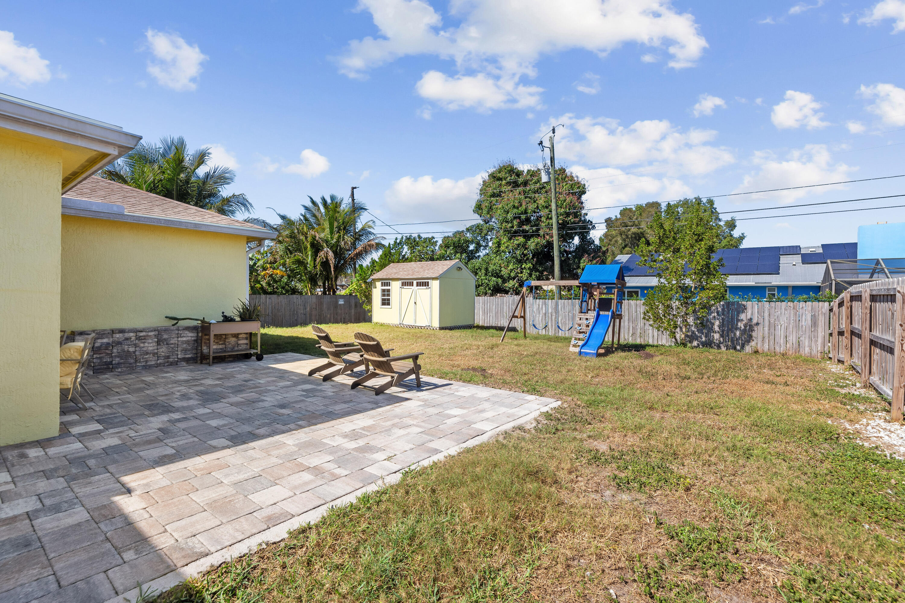 3037 Southeast Iris Street Stuart, FL 34997 - Photo 30 of 36 a view of a backyard with plants and patio