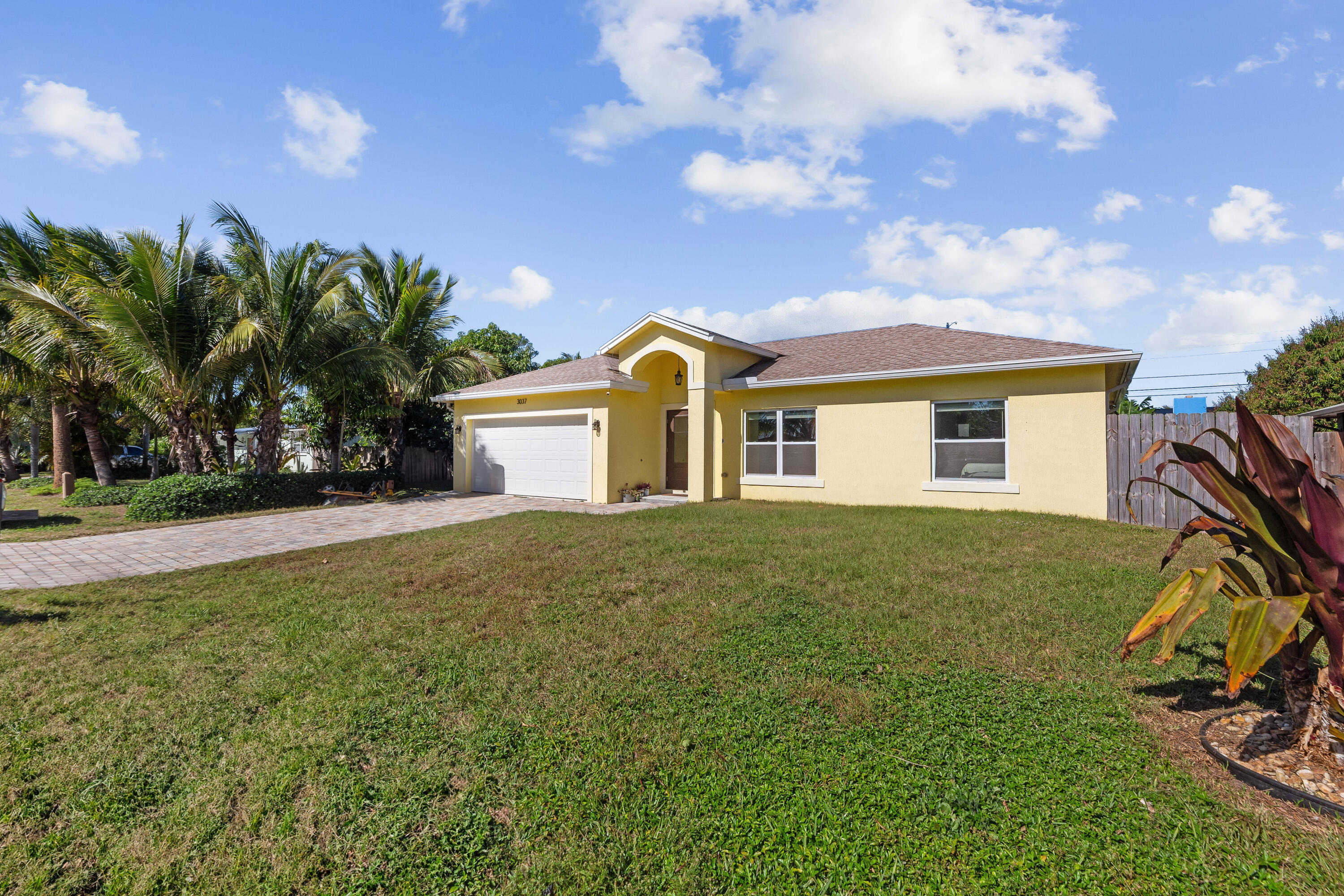 3037 Southeast Iris Street Stuart, FL 34997 - Photo 3 of 36 a view of a house with a backyard