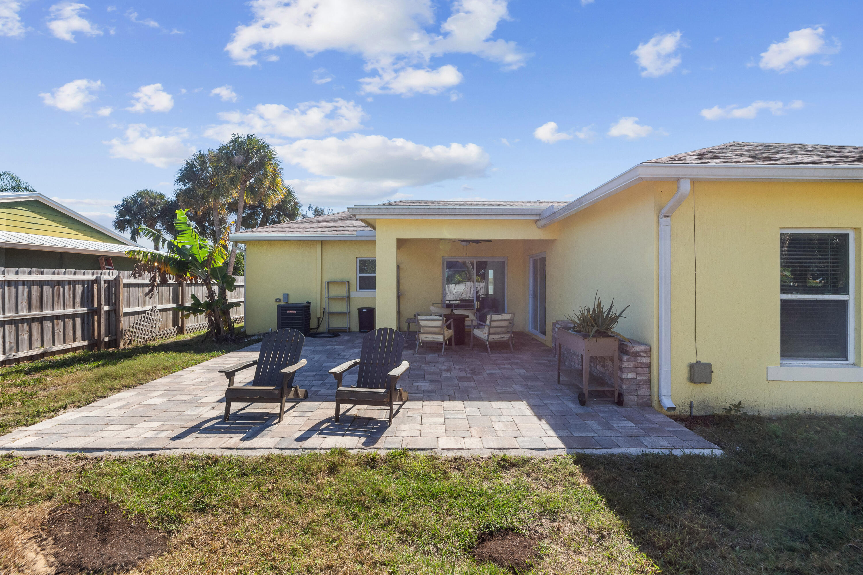 3037 Southeast Iris Street Stuart, FL 34997 - Photo 31 of 36 a view of a house with backyard water fountain and sitting area