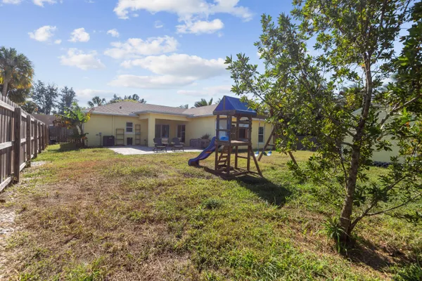a view of a house with backyard porch and sitting area