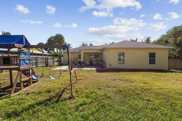 a view of a house with swimming pool and sitting area