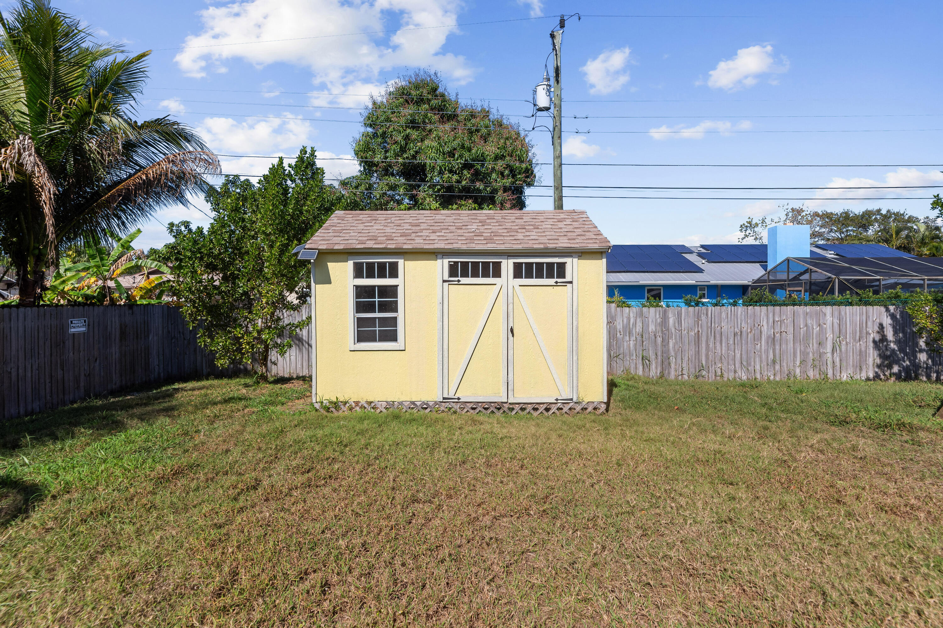 3037 Southeast Iris Street Stuart, FL 34997 - Photo 34 of 36 a front view of a house with a garden