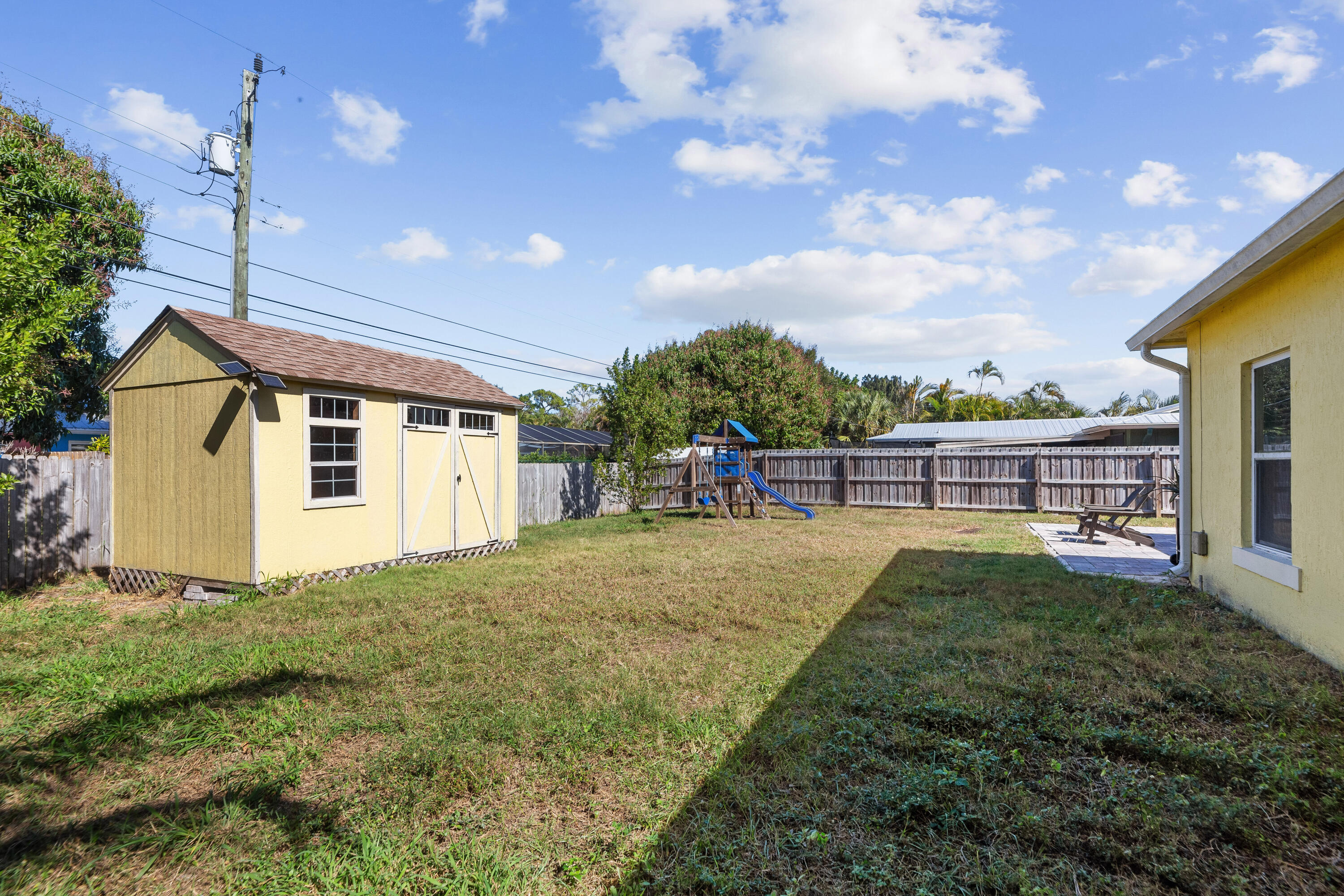 3037 Southeast Iris Street Stuart, FL 34997 - Photo 35 of 36 a view of a backyard with sitting area