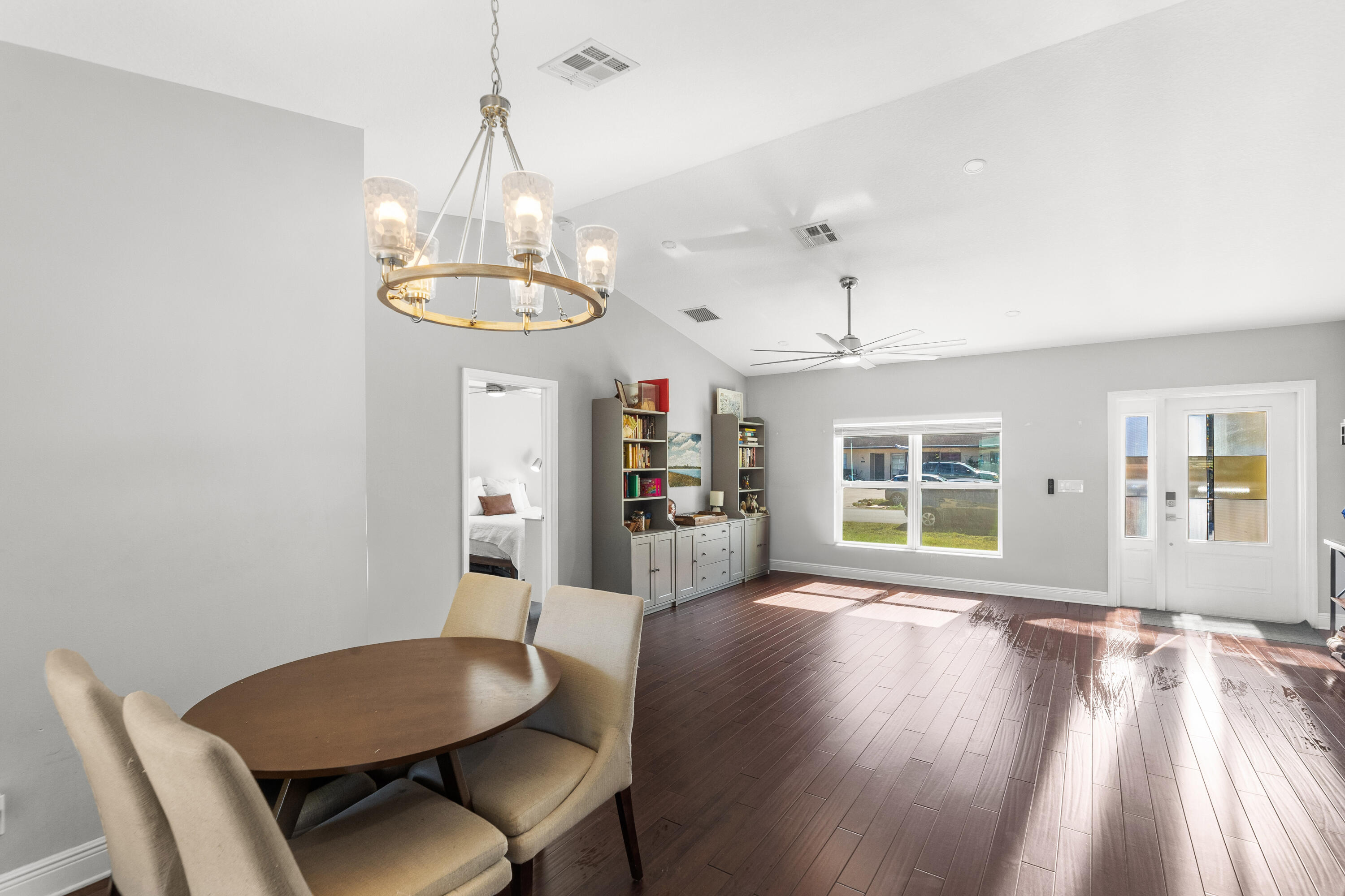 3037 Southeast Iris Street Stuart, FL 34997 - Photo 6 of 36 a view of a dining room with furniture window and wooden floor