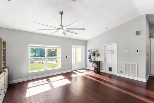 a view of empty room with wooden floor