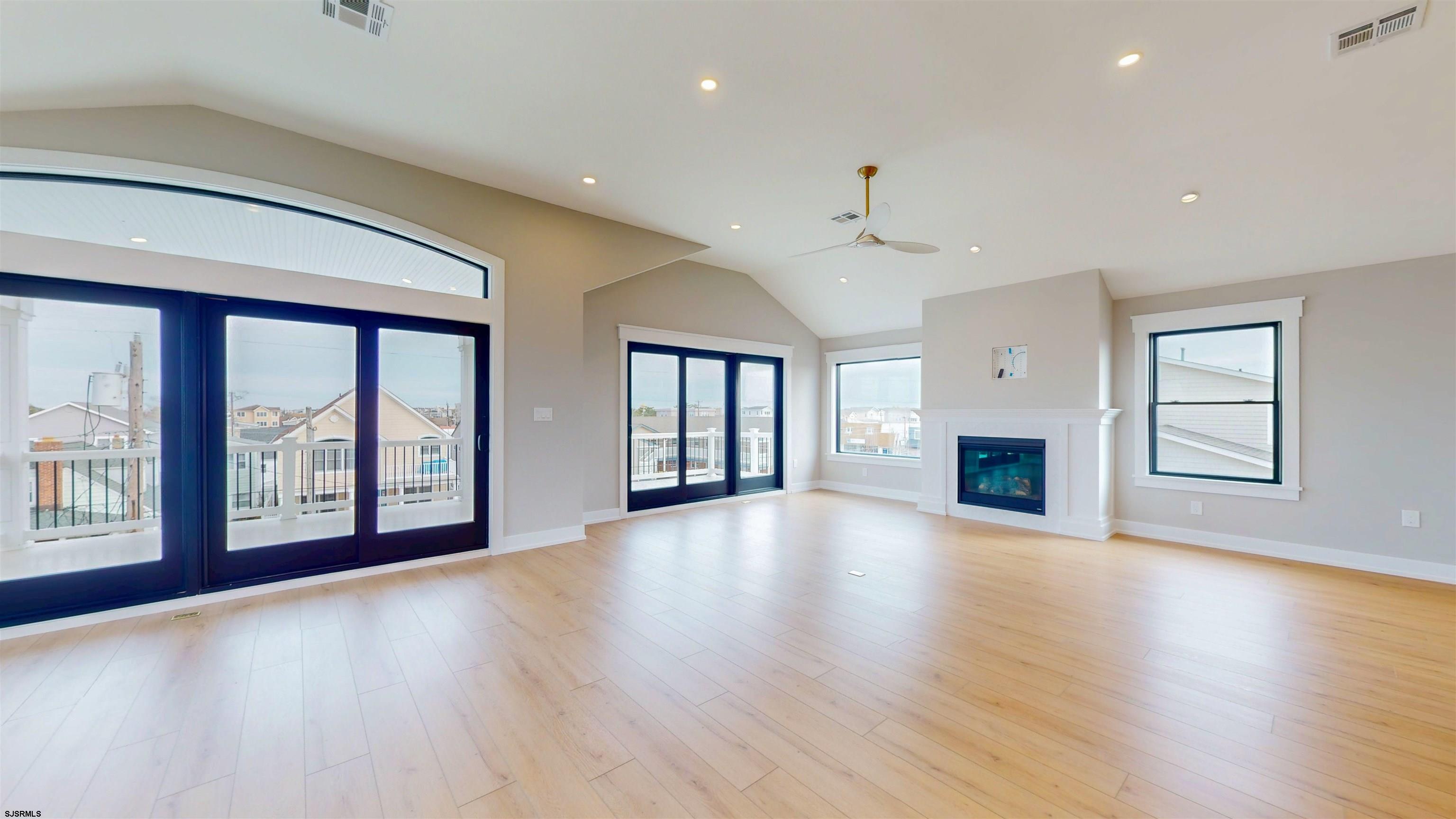 204 12th Street South Brigantine, NJ 08203 - Photo 11 of 63 a view of an empty room with wooden floor and a window