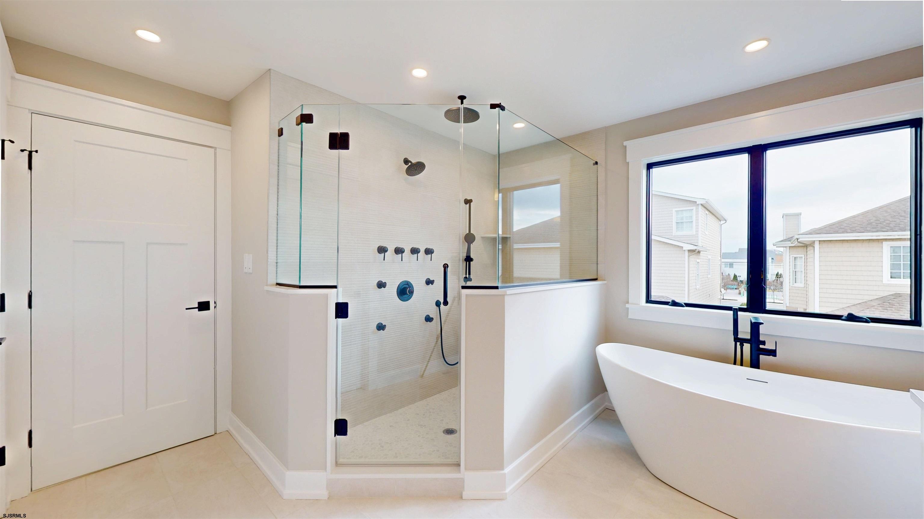 204 12th Street South Brigantine, NJ 08203 - Photo 25 of 63 a bathroom with a bathtub and a shower