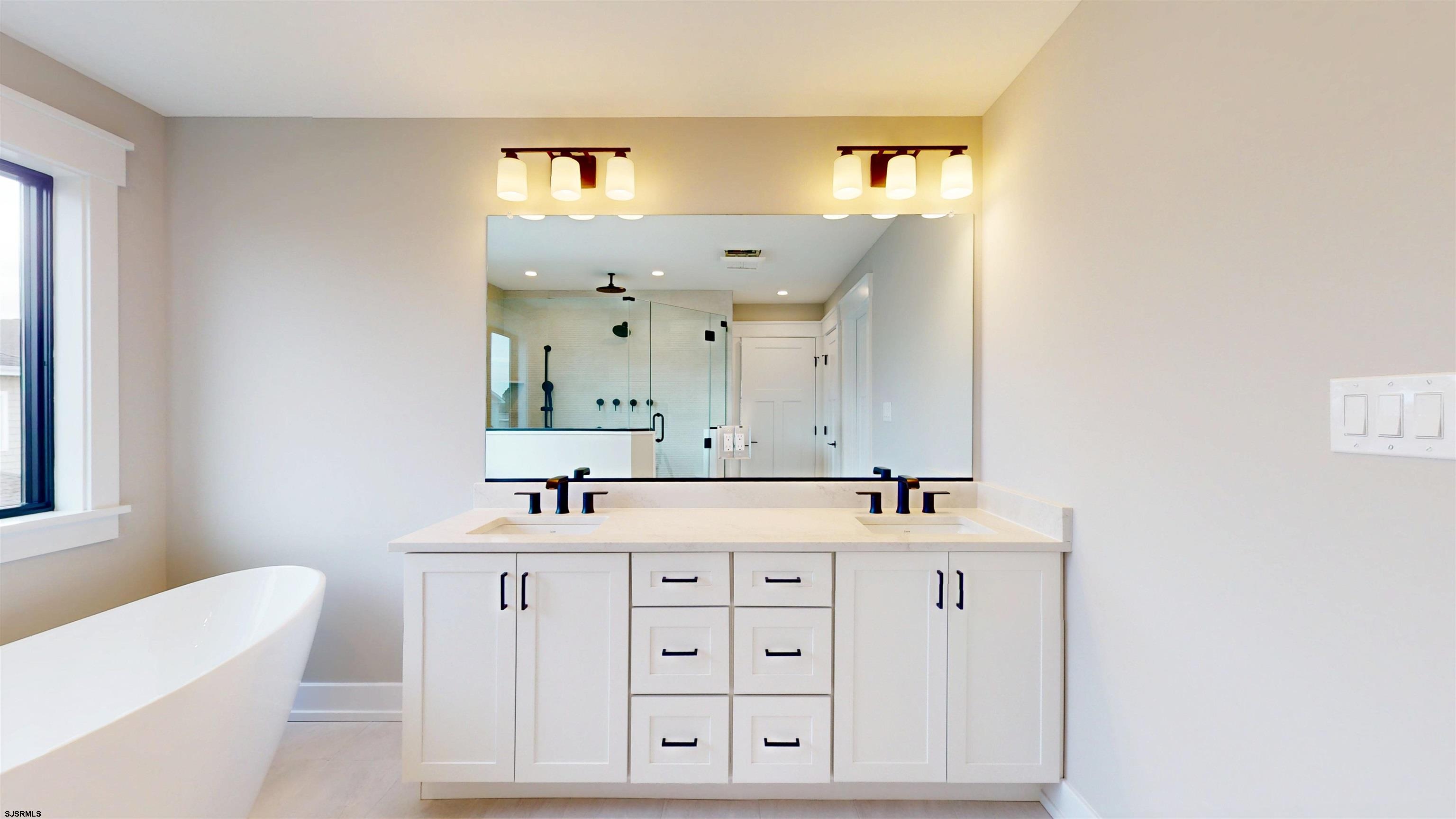 204 12th Street South Brigantine, NJ 08203 - Photo 26 of 63 a bathroom with a sink vanity and a mirror