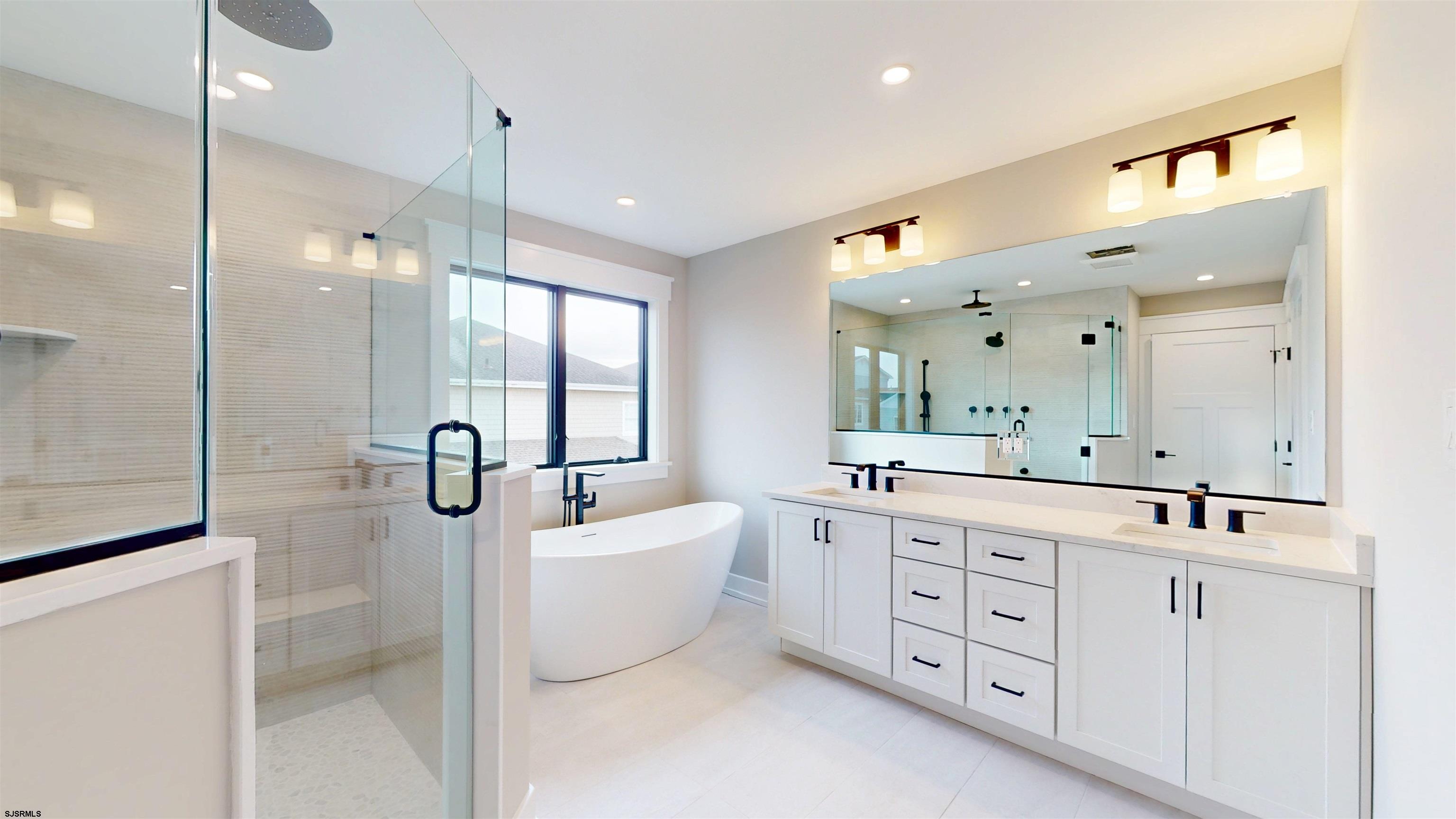204 12th Street South Brigantine, NJ 08203 - Photo 29 of 63 a bathroom with a double vanity sink mirror and bathtub
