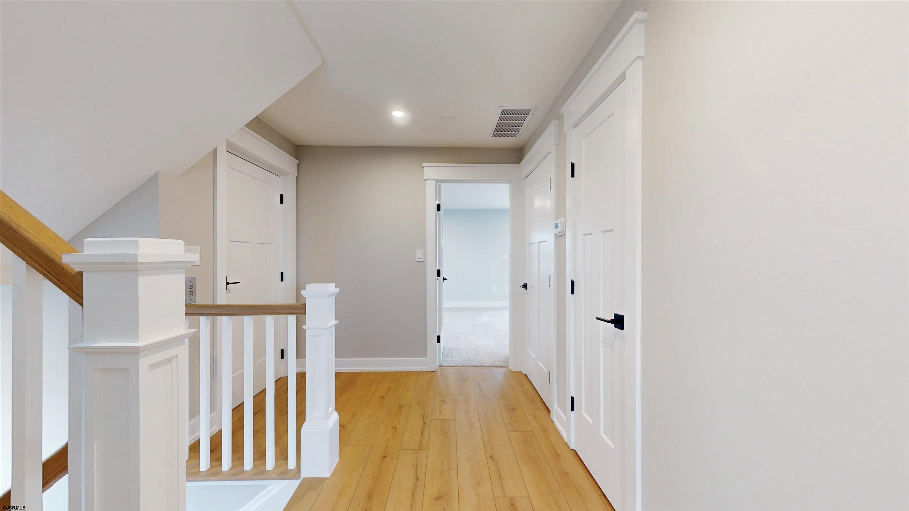 204 12th Street South Brigantine, NJ 08203 - Photo 30 of 63 a view of a hallway with wooden floor and staircase