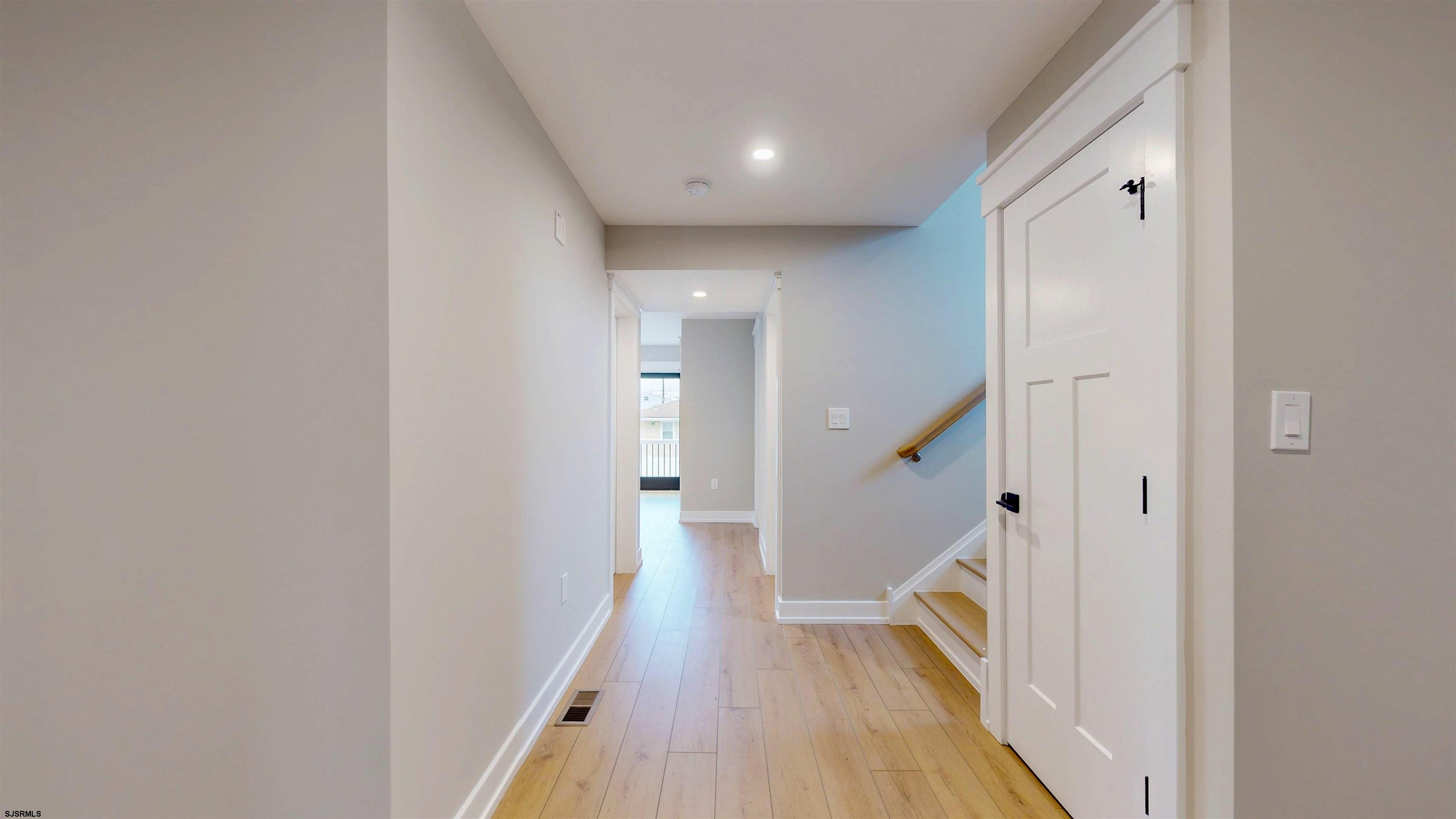 204 12th Street South Brigantine, NJ 08203 - Photo 32 of 63 a view of a hallway with wooden floor and staircase