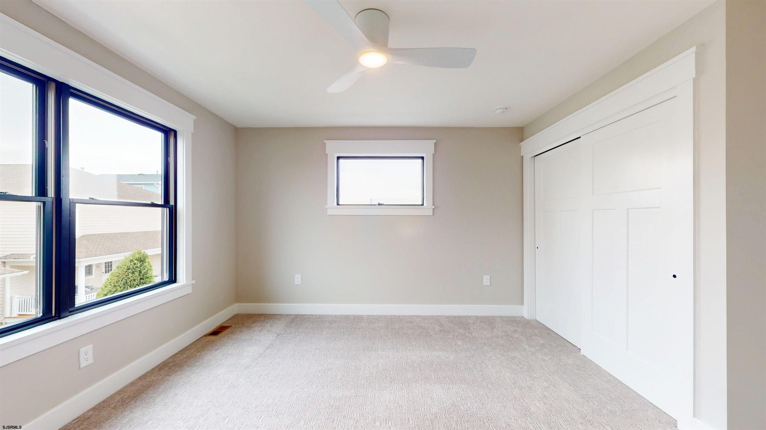 204 12th Street South Brigantine, NJ 08203 - Photo 34 of 63 wooden floor in an empty room with a window