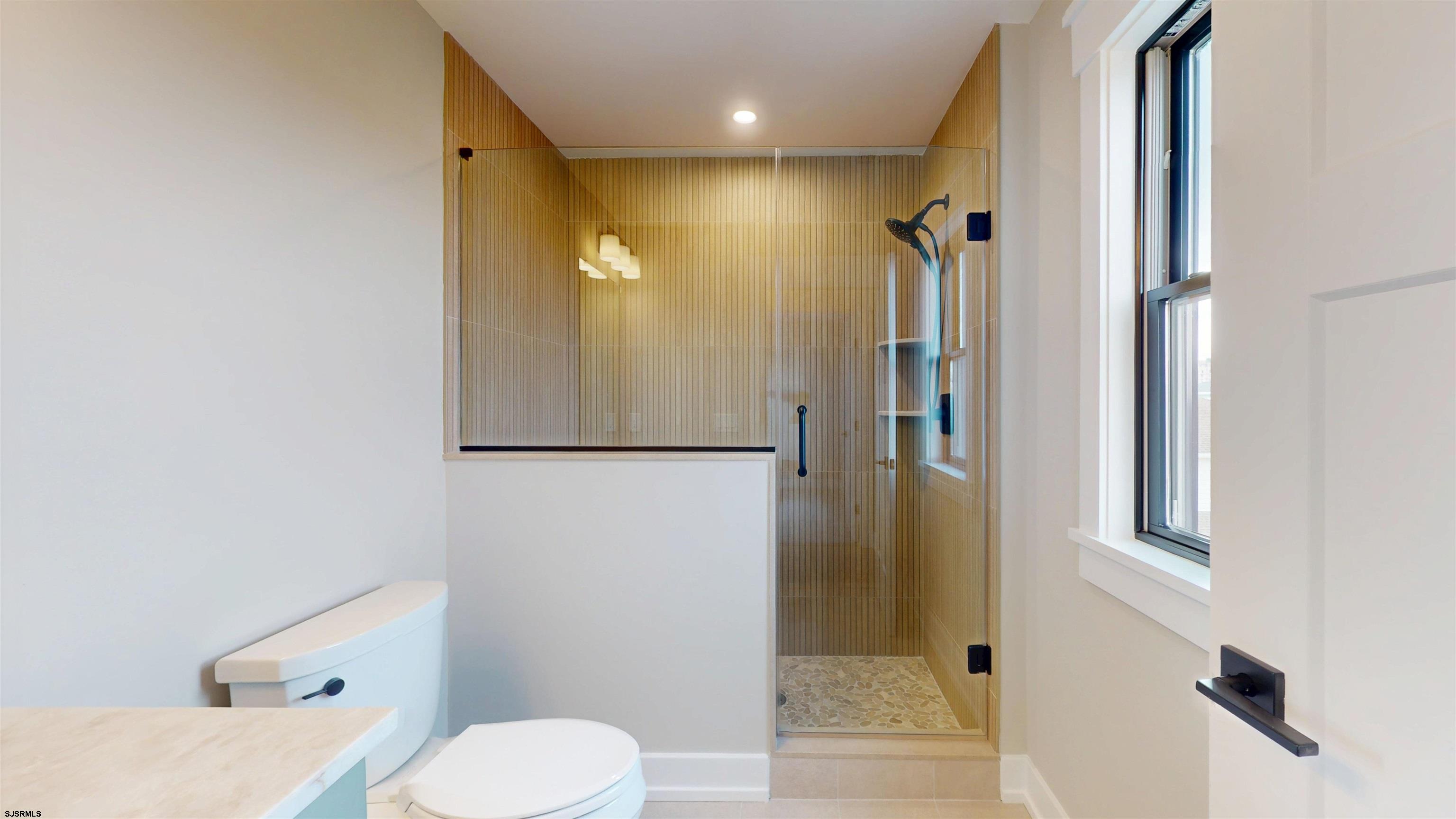 204 12th Street South Brigantine, NJ 08203 - Photo 36 of 63 a bathroom with a toilet shower and a sink