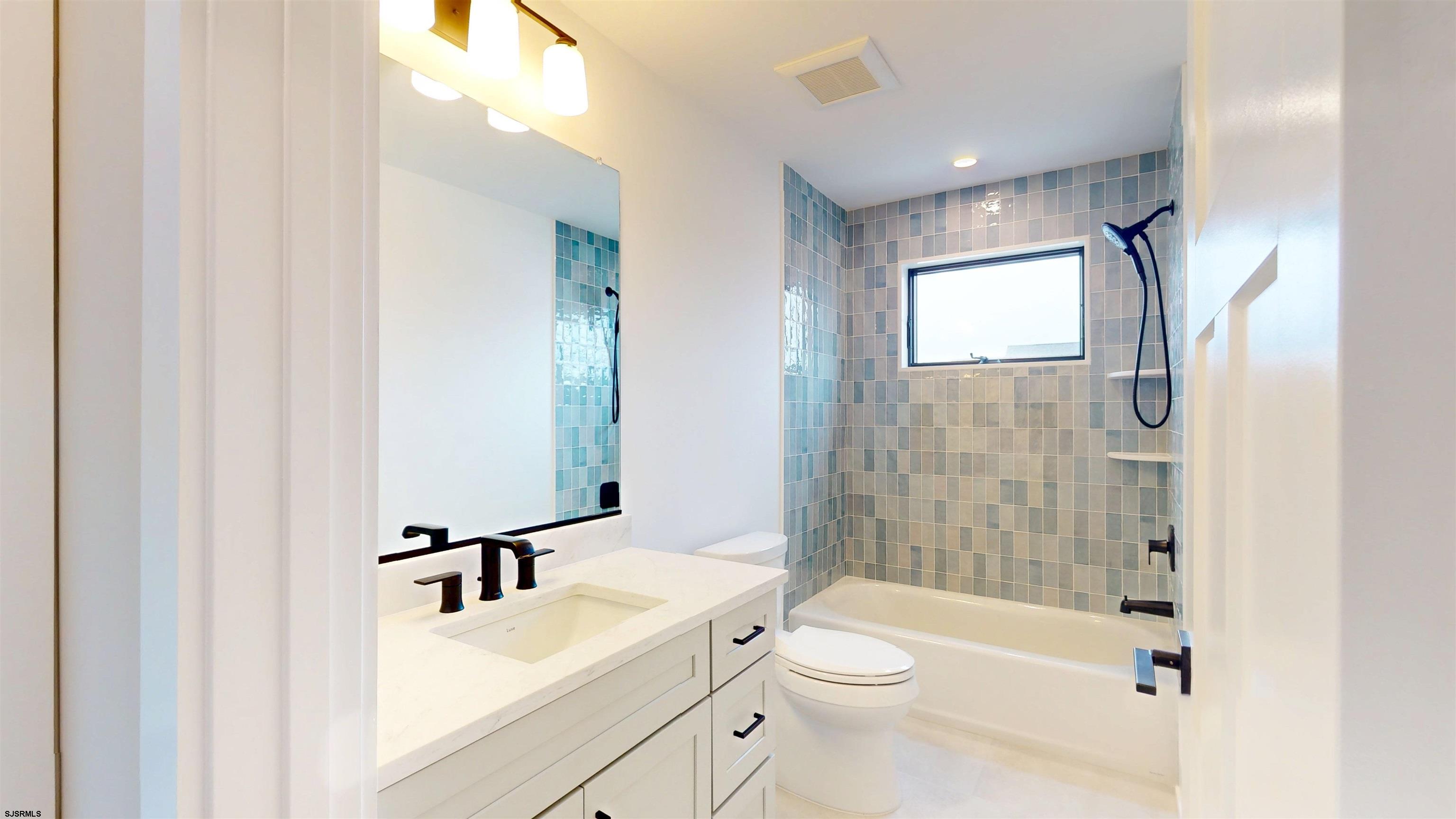204 12th Street South Brigantine, NJ 08203 - Photo 39 of 63 a bathroom with a sink a toilet and shower