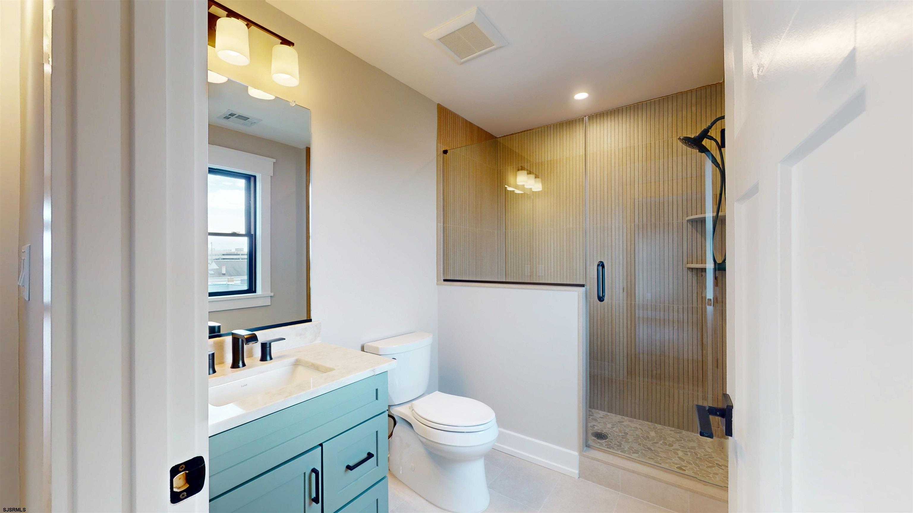 204 12th Street South Brigantine, NJ 08203 - Photo 44 of 63 a bathroom with a sink a toilet and shower