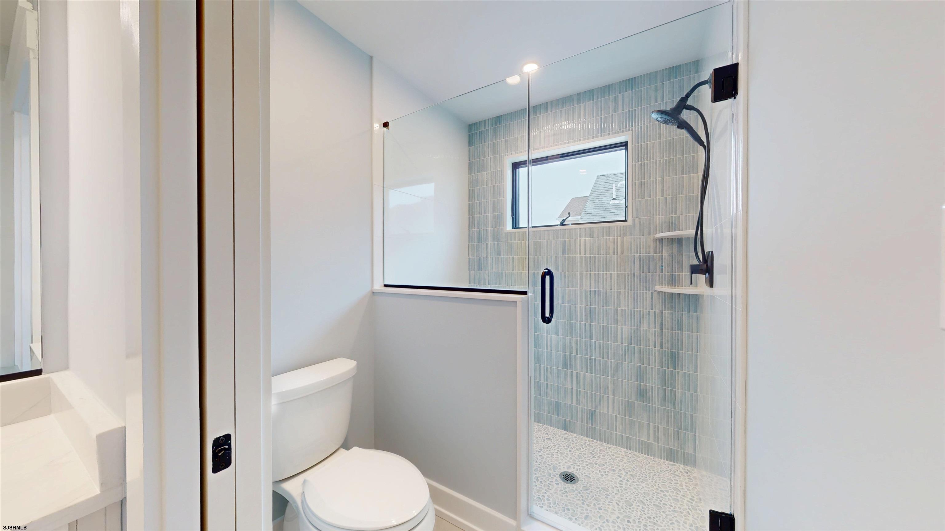 204 12th Street South Brigantine, NJ 08203 - Photo 46 of 63 a bathroom with a shower and toilet