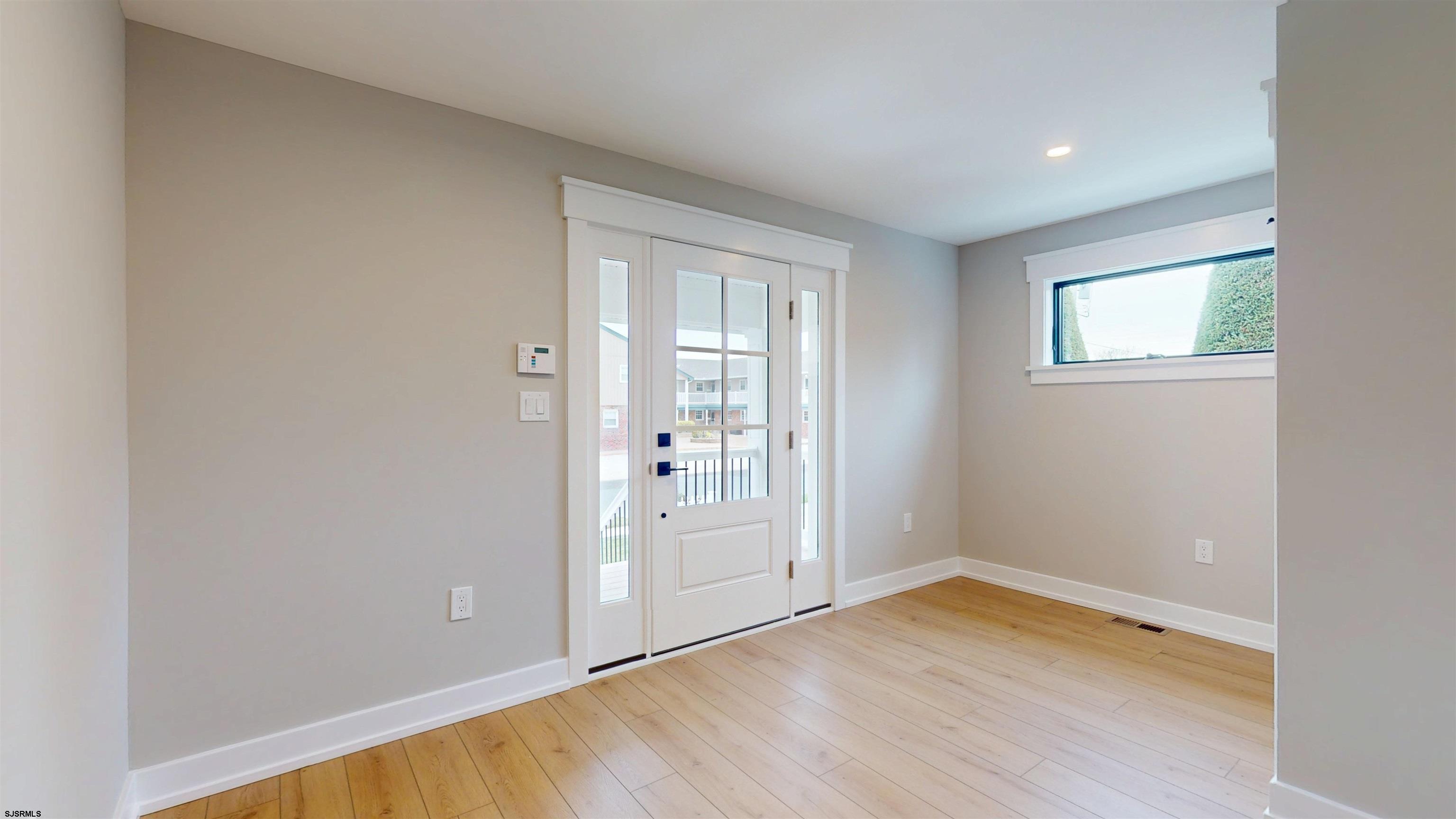 204 12th Street South Brigantine, NJ 08203 - Photo 53 of 63 an empty room with wooden floor and windows