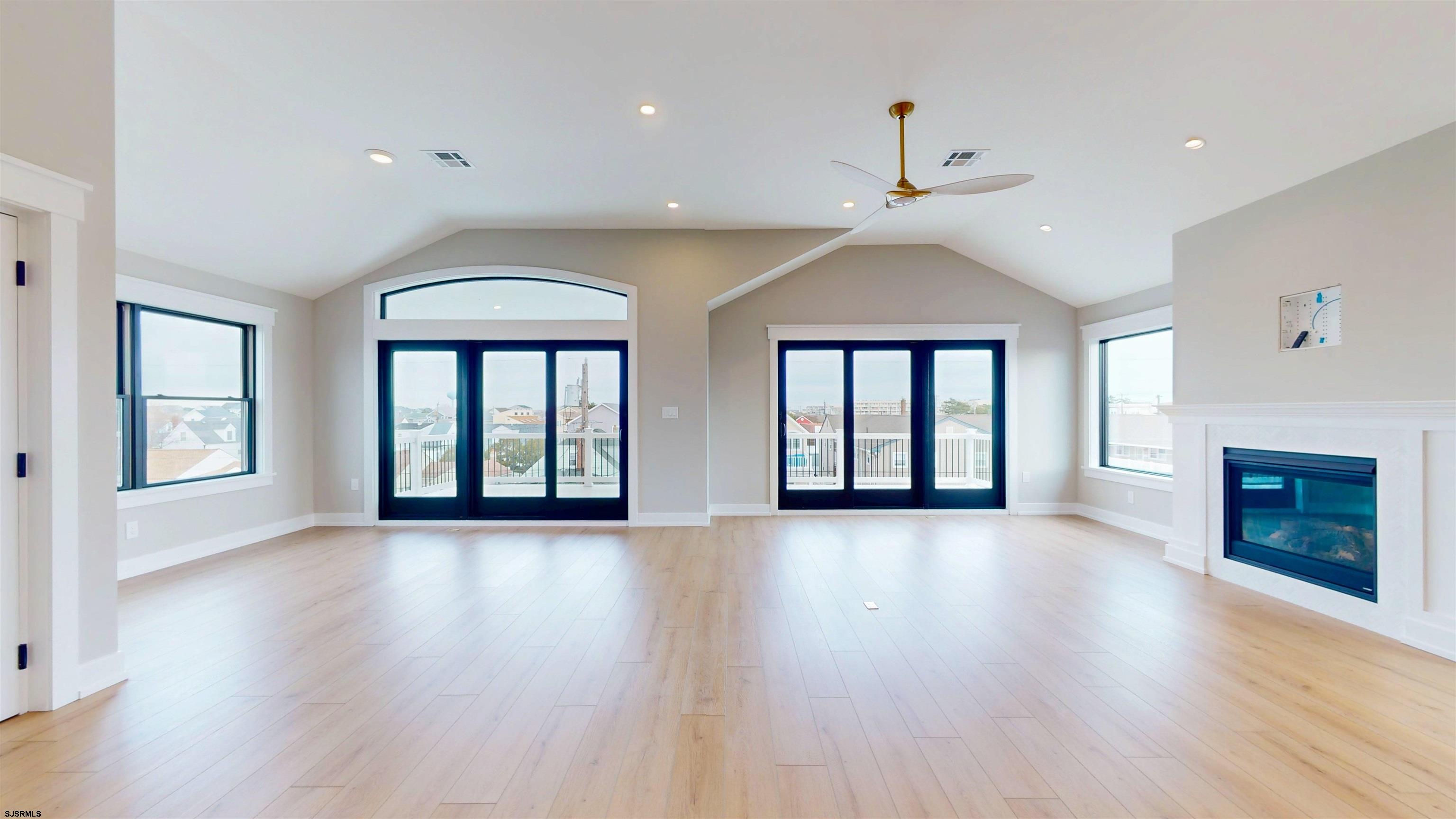 204 12th Street South Brigantine, NJ 08203 - Photo 10 of 63 an empty room with wooden floor chandelier and windows