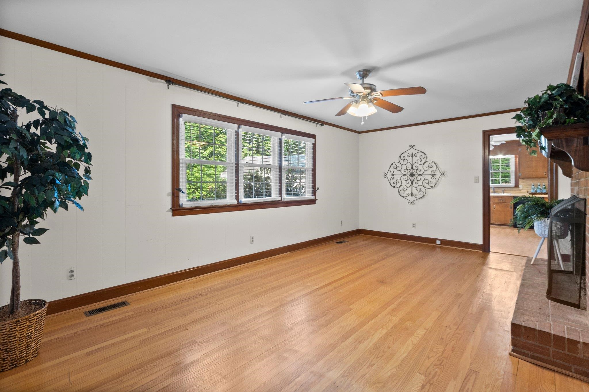 1208 Country Ridge Drive Raleigh, NC 27609 - Photo 16 of 32 Hardwood floors, triple window, and ceiling fan in the Family Room. Family Room