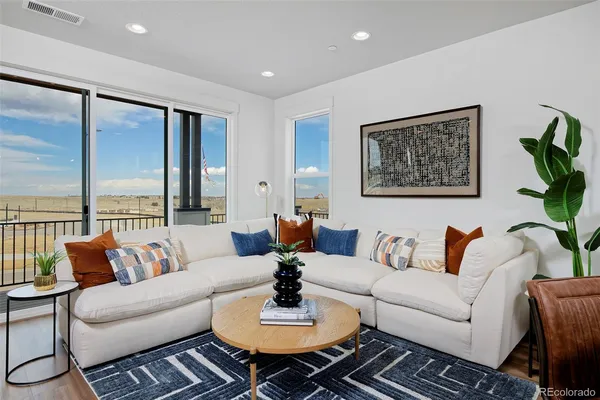 a living room with a flat screen tv and a fireplace