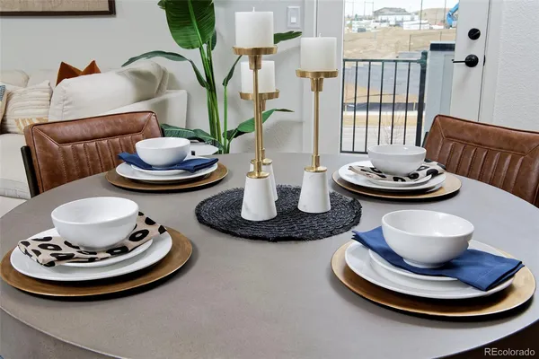 a kitchen with a refrigerator a stove and white cabinets