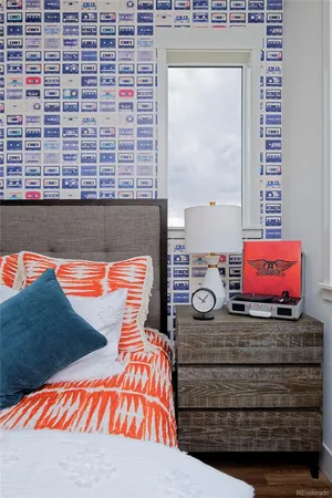 a bedroom with a bed and a lamp next to a window