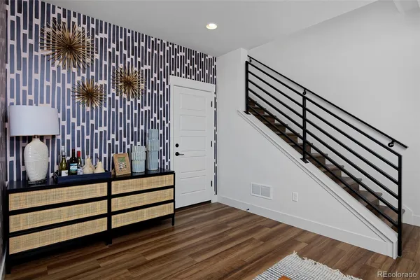 a kitchen with stainless steel appliances kitchen island granite countertop a dining table and chairs