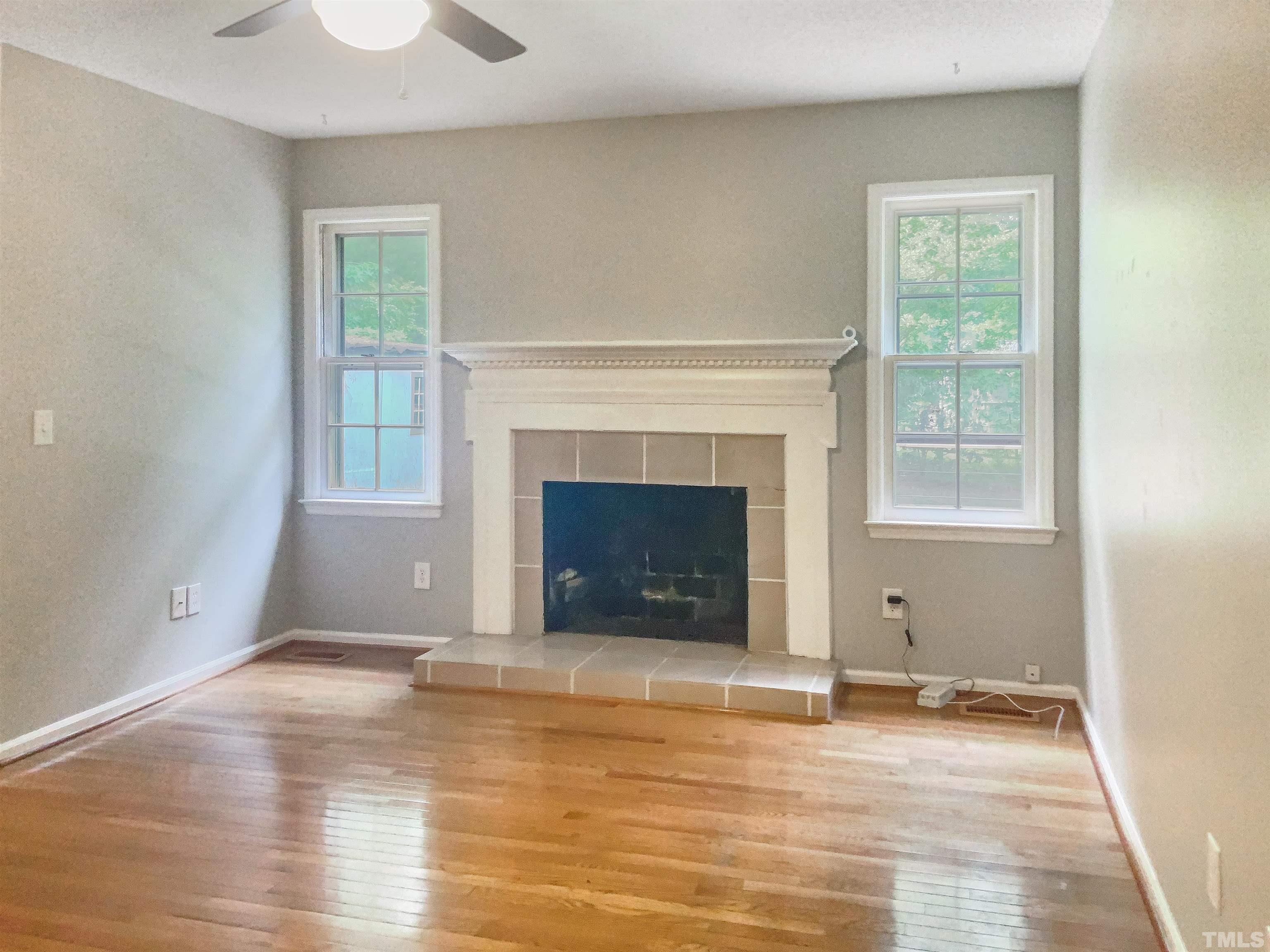 7312 Mine Valley Road Raleigh, NC 27615 - Photo 12 of 19 a view of empty room with wooden floor and fireplace