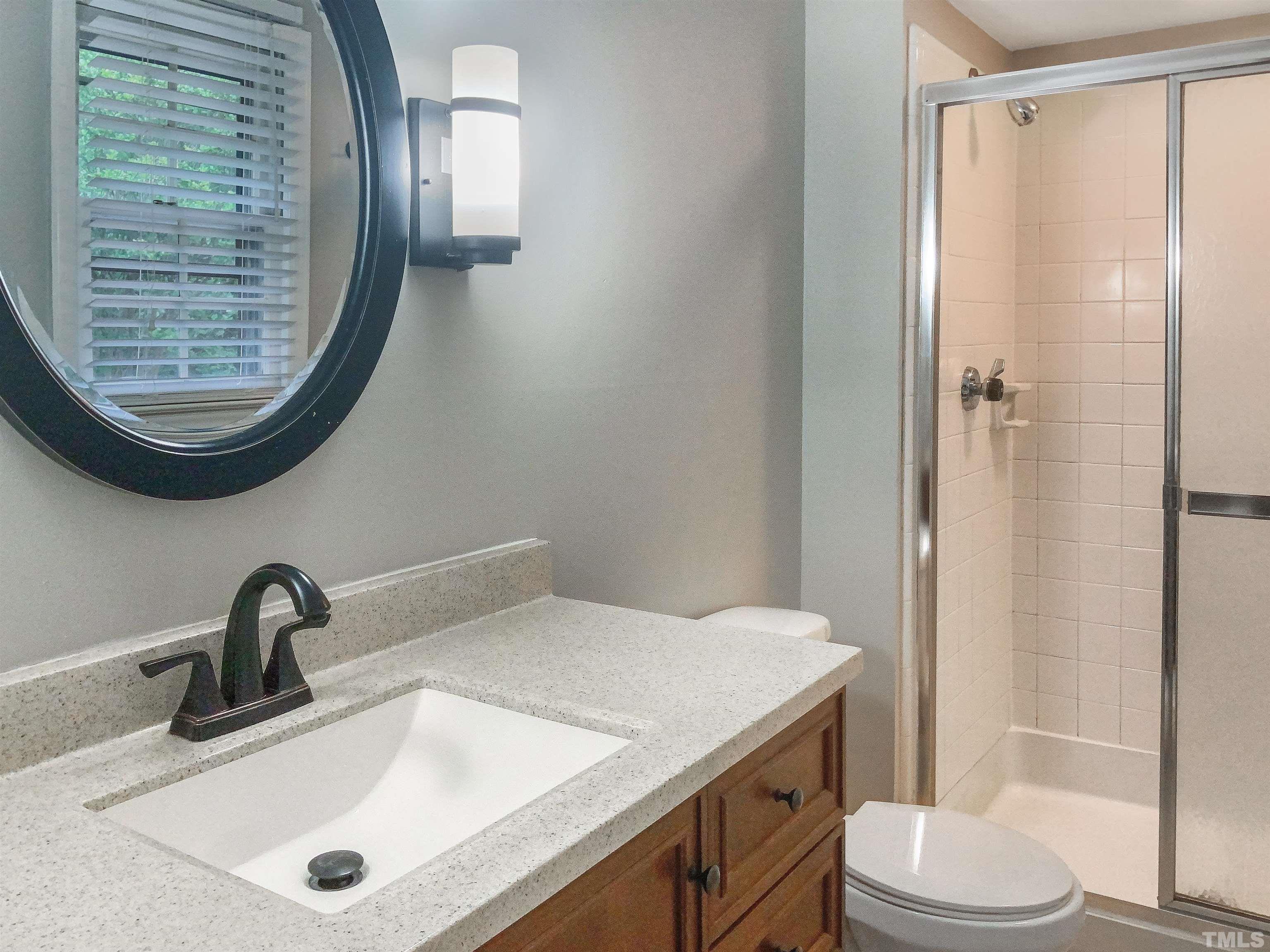 7312 Mine Valley Road Raleigh, NC 27615 - Photo 19 of 19 a bathroom with a sink a toilet and shower
