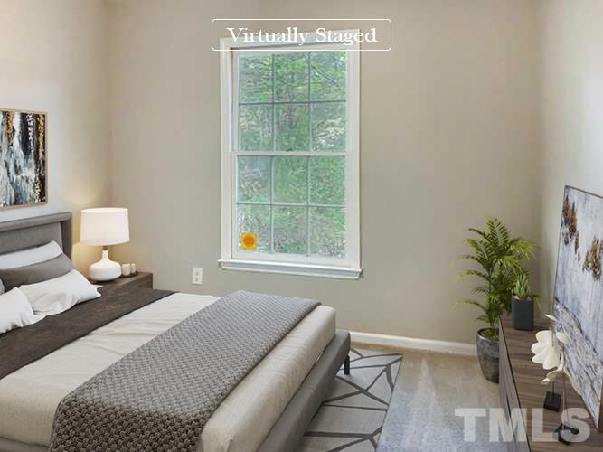 7312 Mine Valley Road Raleigh, NC 27615 - Photo 3 of 19 a bedroom with a bed and a potted plant