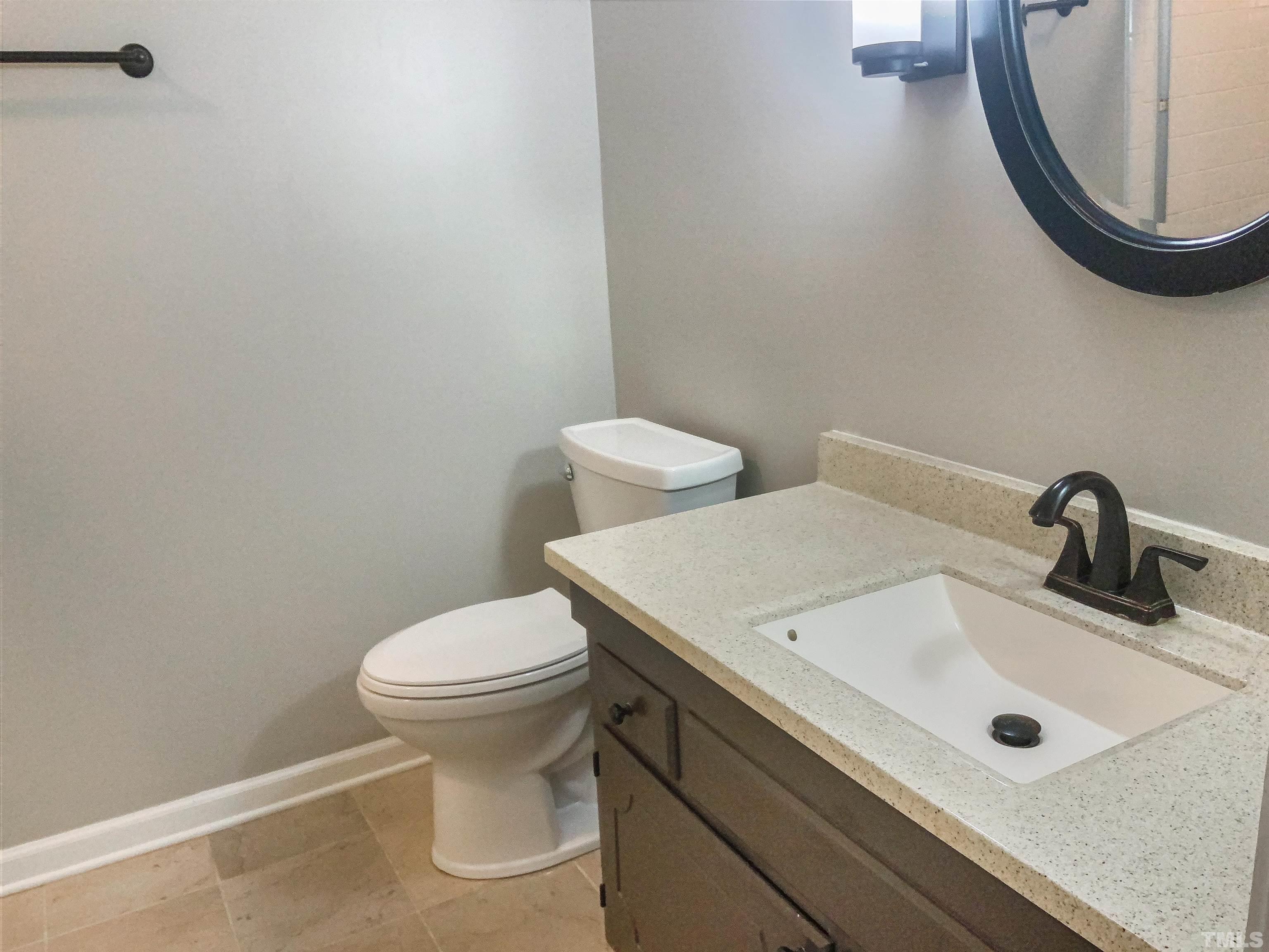 7312 Mine Valley Road Raleigh, NC 27615 - Photo 6 of 19 a bathroom with a sink and a toilet