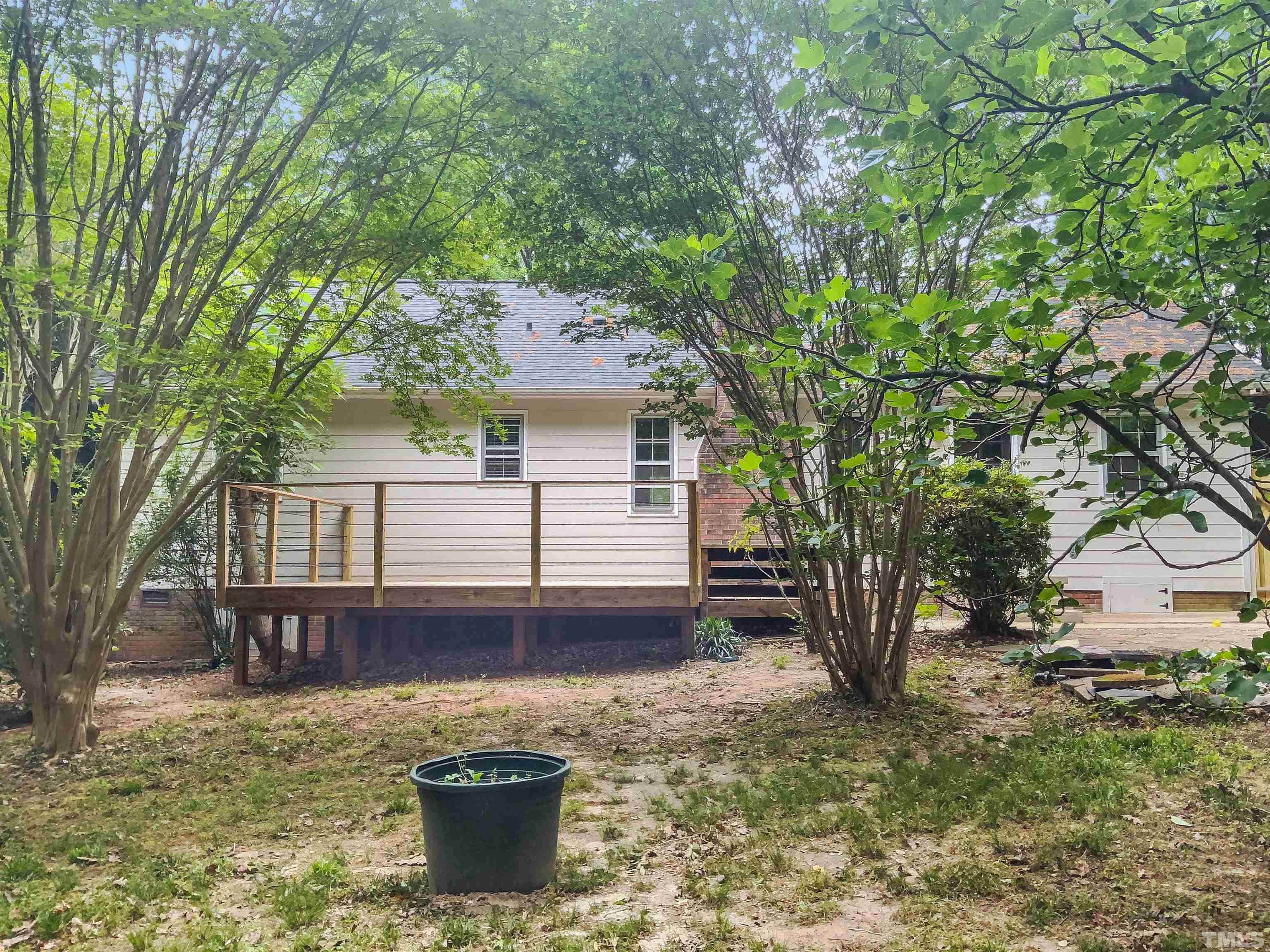 7312 Mine Valley Road Raleigh, NC 27615 - Photo 7 of 19 a backyard of a house with wooden deck and seating space